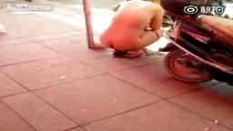 Chinese girl pissing naked in street